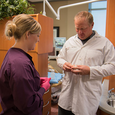 Dr. Pooley working with a team member at River Valley Dental.